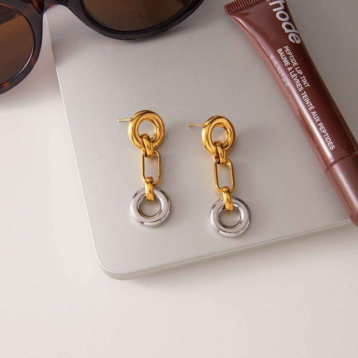 18K gold hoop earrings, a luxurious and sophisticated pair of stud earrings.